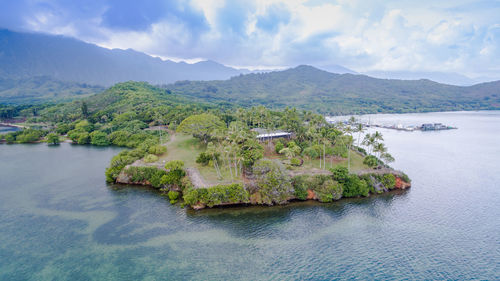 High angle view of river amidst mountains against sky