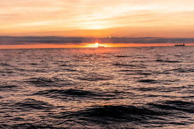 Scenic view of sea against romantic sky at sunset