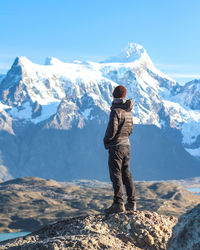 Rear view of man standing on mountain