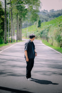 Portrait of young woman walking on road