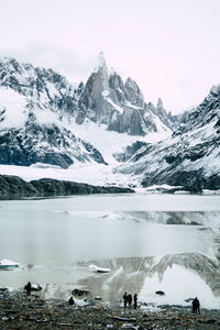 Glacial lake with snowcapped mountains in winter