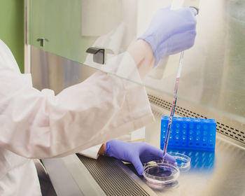 Cropped hands of doctor doing scientific experiment in laboratory