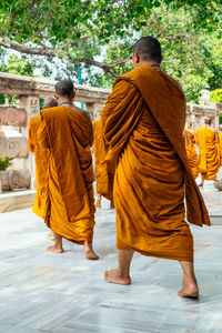 Rear view of men walking in temple