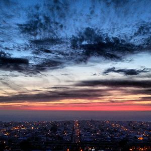 Cityscape against cloudy sky