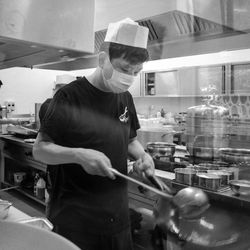 Man working in kitchen at restaurant