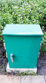 Close-up of garbage bin against plants