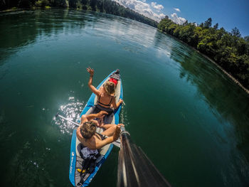 High angle view of man sitting in lake