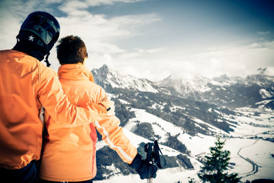 People standing on snow covered landscape