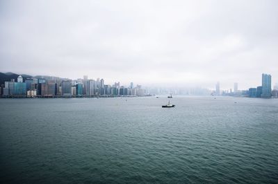 Panoramic view of sea and buildings against sky