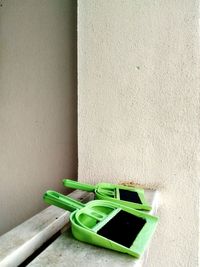 Close-up of dustpans and brooms on railing
