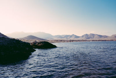 Scenic view of sea with mountains in background