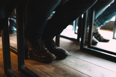 Low section of man on hardwood floor