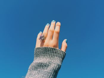 Low angle view of hand against sky