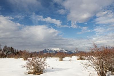 Scenic view of snow covered landscape against sky