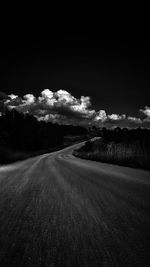 Empty road on field against sky