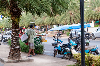 Rear view of people walking on road