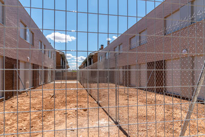 Exterior view of modern semi-detached townhouses with brick facade. sunny day