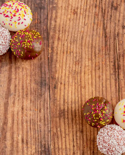 High angle view of multi colored candies on wooden table