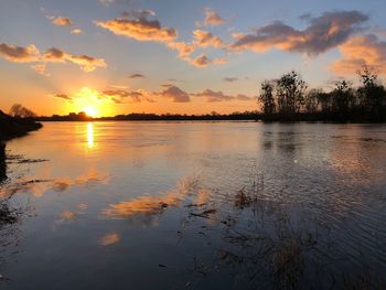 Scenic view of lake against orange sky