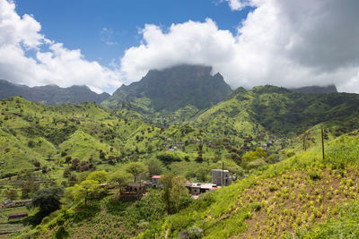 Scenic view of trees and mountains against sky