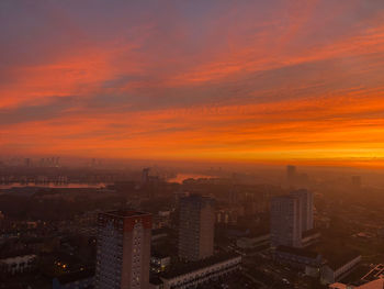 High angle view of buildings against sky during sunset