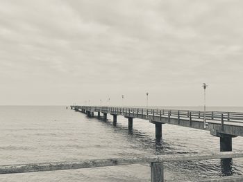 Pier over sea against sky