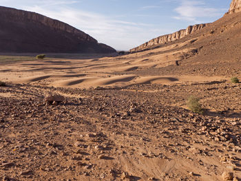 Scenic view of arid landscape against sky