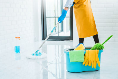 Midsection of woman working with umbrella
