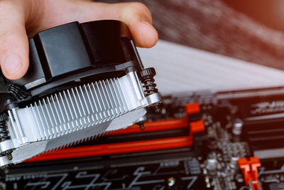 Cropped image of technician installing cpu cooler fan
