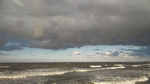 Scenic view of sea against dramatic sky