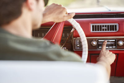 Rear view of man driving car