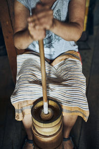 Woman making butter with butter churn. old traditional method making of butter