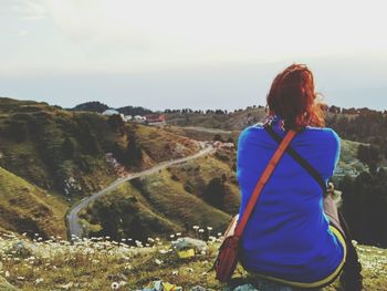 Rear view of woman standing on landscape