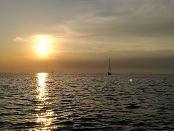 View of sailboat in sea during sunset