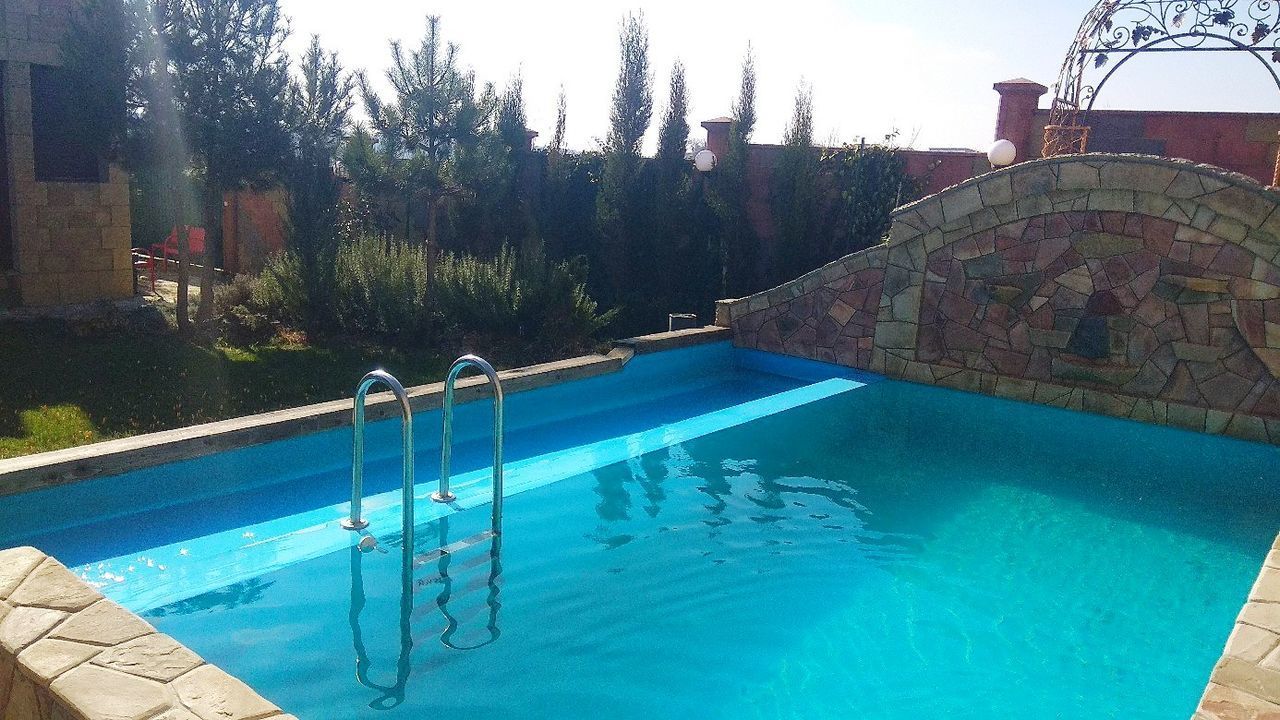 VIEW OF SWIMMING POOL AGAINST BLUE SKY