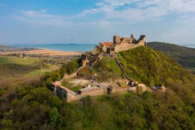 Aerial view about castle of szigliget with lake balaton at the background. spring landscape.