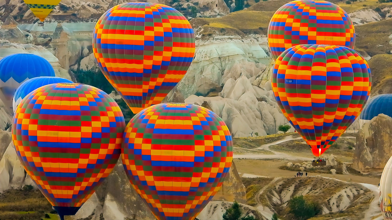 hot air balloon, multi colored, balloon, hot air ballooning, travel, vehicle, transportation, air vehicle, no people, pattern, day, nature, outdoors, travel destinations, tradition, environment, ballooning festival, tourism, toy, landscape, aircraft