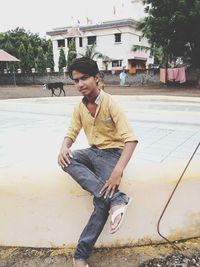 Portrait of young man sitting outdoors