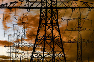 Low angle view of electricity pylon against sky