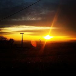 Scenic view of landscape against sky at sunset