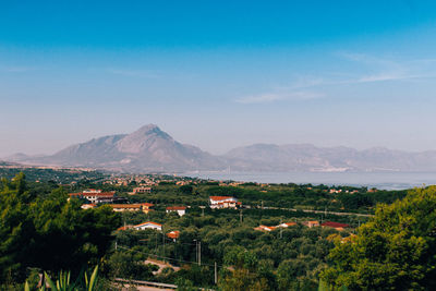 Scenic view of mountains against blue sky