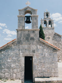 Low angle view of bell tower against sky