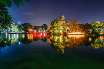 Scenic view of lake against sky at night