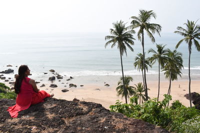 Woman looking at sea against sky