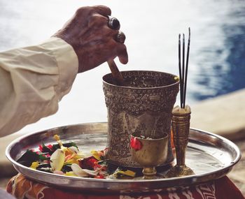 Cropped hand of man performing prayer