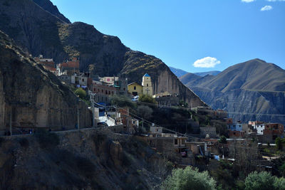 Panoramic view of buildings in city against sky