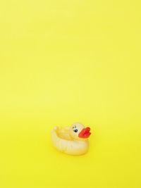 Close-up of stuffed toy over yellow background