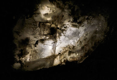 Close-up of illuminated lighting equipment against black background