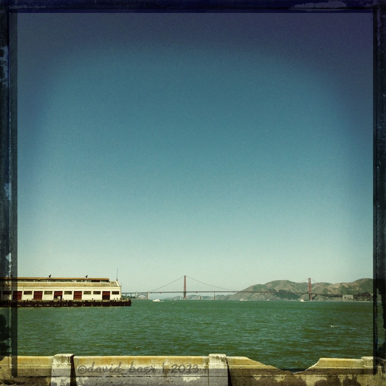 clear sky, copy space, water, sea, built structure, architecture, blue, transfer print, connection, bridge, bridge - man made structure, tranquility, tranquil scene, auto post production filter, railing, river, engineering, waterfront, nature, scenics