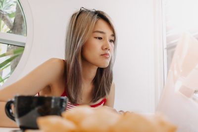 Portrait of smiling young woman using mobile phone